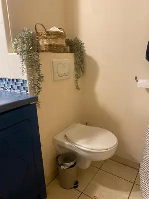 a bathroom with a white toilet and a sink at Studio 50M de la mer in Saint-Laurent-du-Var