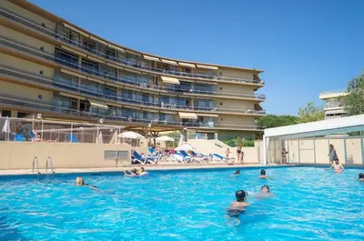 a group of people swimming in a swimming pool at Studio 50M de la mer in Saint-Laurent-du-Var