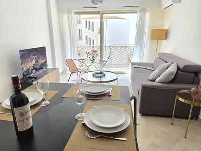 a living room with a table with a bottle of wine at 