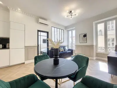 a living room with a table and green chairs at Nestor&Jeeves - EMERAUDE - Central - Modern in Nice