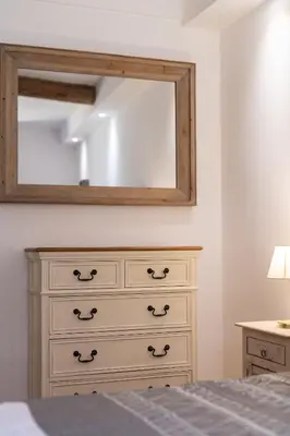 a bedroom with a dresser and a mirror at 