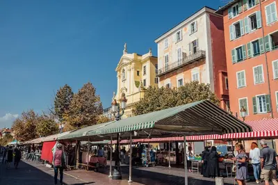 a group of people walking around a market in a city at 