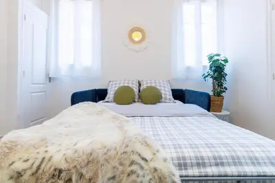 a bedroom with a bed with a blanket on it at Charmant studio refait à neuf quartier du port in Nice
