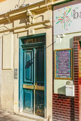 a building with a blue door on the side of it at Charmant studio refait à neuf quartier du port in Nice