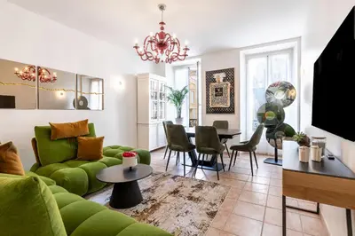 a living room with a green couch and a table at Appartement 2 chambres proche plage climatisé in Nice