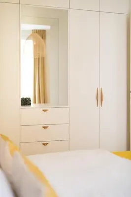 a yellow bedroom with a yellow bed with white pillows at La Rotonde Lympia, vintage chic and design in Nice