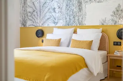 a living room with a couch and shelves at La Rotonde Lympia, vintage chic and design in Nice