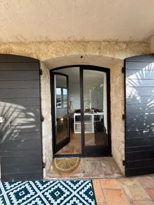 an entrance to a house with a glass door at Maison Lou in Falicon