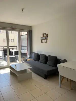 a living room with a couch and a table at Nice 2P quiet, tram, convenient in Nice