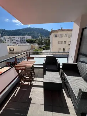 a balcony with tables and chairs on a building at Nice 2P quiet, tram, convenient in Nice