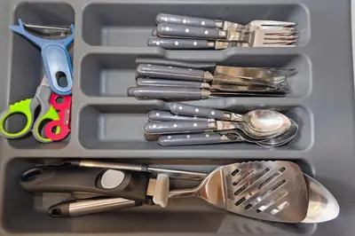 a container filled with utensils and spoons at L'Opéra - Hypercentre - Cosy - No elevator - Minimalist - Sea in Nice