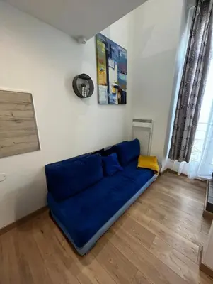 a blue couch sitting in a living room at Studio Masséna Nice in Nice