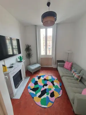 a living room with a couch and a fireplace at Superbe appartement niçois in Nice