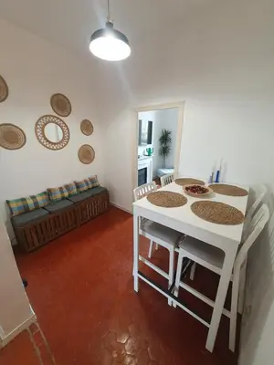 a living room with a table and a couch at Superbe appartement niçois in Nice