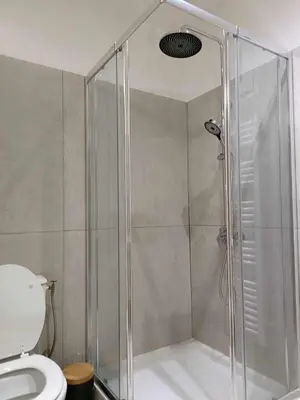 a shower with a glass door in a bathroom at Appartement studio in Nice