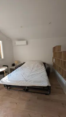 a white bedroom with a bed in a room at Appartement studio in Nice