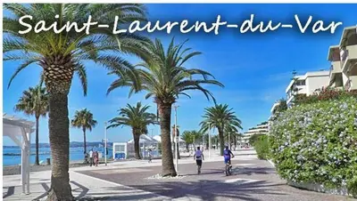a person riding a bike down a street with palm trees at Riviera Retreat - Steps to Beach & Shops, Balcony & AC in Saint-Laurent-du-Var