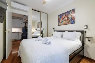 a bedroom with a large bed with white sheets at Ultra Central 1 Bdr Air-Conditionned in Nice