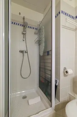 a bathroom with a shower with a glass door at Ultra Central 1 Bdr Air-Conditionned in Nice