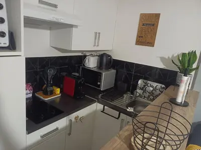 a kitchen with a counter top with a laptop on it at Studio calme proximité plage in Saint-Laurent-du-Var
