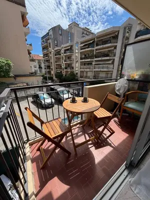 a balcony with a table and chairs on a balcony at Cœur de Nice - Plage à 5min in Nice
