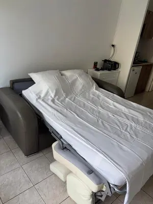 a hospital bed with white sheets in a room at Cœur de Nice - Plage à 5min in Nice