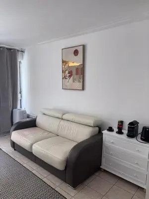 a living room with a couch and a table at Cœur de Nice - Plage à 5min in Nice