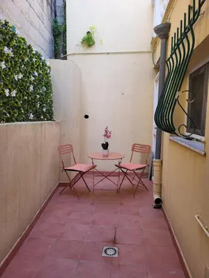 a small patio with two chairs and a table at Studio haut de gamme in Nice