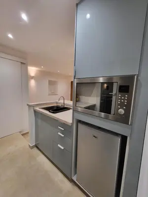 a kitchen with a sink and a microwave at Studio haut de gamme in Nice