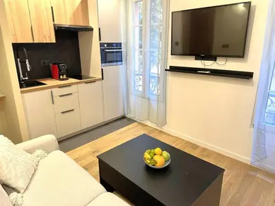 a living room with a bowl of fruit on a table at Studio Californien à deux pas de la plage in Nice