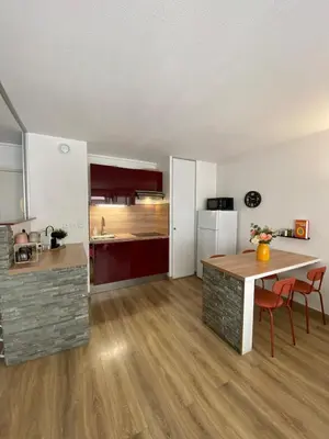 a kitchen and dining room with a table in a room at Le Spot Niçois in Nice