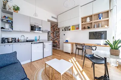 a kitchen and living room with a couch and a table at Studio lumineux Centre-ville in Nice