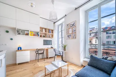 a living room with a couch and a desk at Studio lumineux Centre-ville in Nice