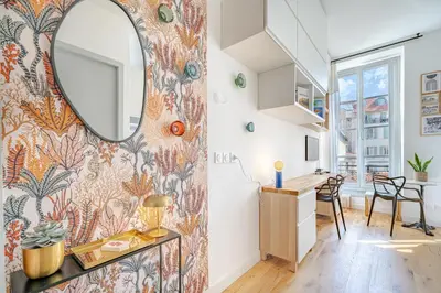a room with a mirror on the wall and a desk at Studio lumineux Centre-ville in Nice