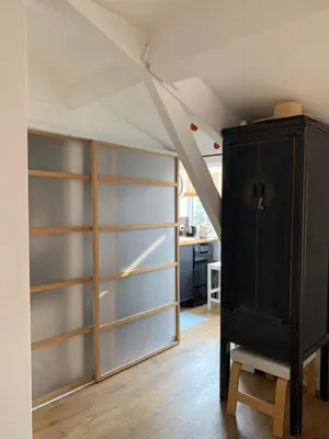 a room with shelves and a cabinet in a attic at Grand studio Zen à côté de la promenade des Anglais in Nice