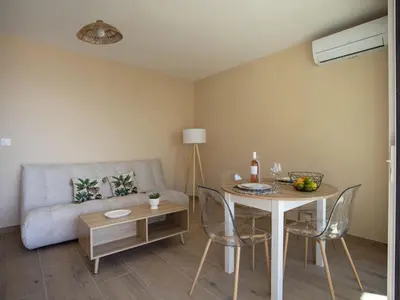 a living room with a table and a couch at Apartment Cros de Cagnes-2 by Interhome in Cagnes-sur-Mer