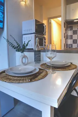 a table with two plates and a wine glass at Nouveau charmant Studio à 5 Minutes de la mer in Nice