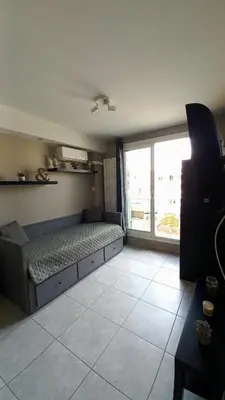 a bedroom with a bed and a large window at Nice flat near sea and center in Nice