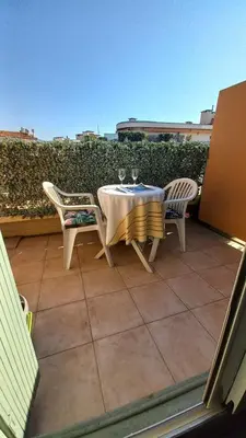 a table and chairs sitting on a patio at Nice flat near sea and center in Nice