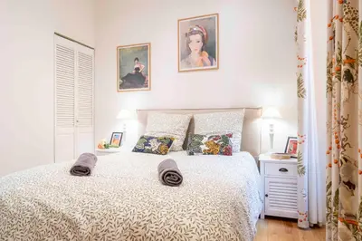 a bedroom with a bed with two pillows on it at Beautiful Provencal apartment, fully equipped, beach 300m away - FONTAINE 3 in Nice