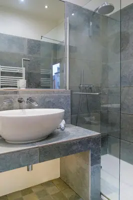 a bathroom with a sink and a glass shower at Beautiful Provencal apartment, fully equipped, beach 300m away - FONTAINE 3 in Nice
