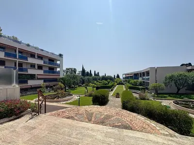 a view of a building and a courtyard with bushes at Azur Stay in Nice