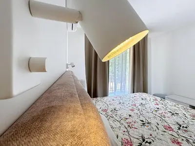 a bedroom with a bed and a large window at Azur Stay in Nice