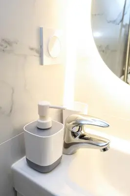 a bathroom sink with a faucet and a mirror at Cozy studio in Nice Désambrois in Nice