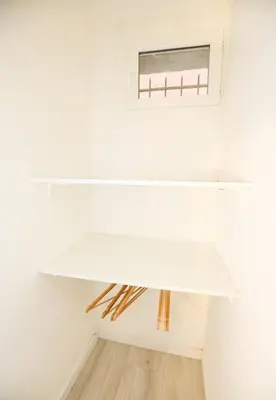 a white shelf in a room with a window at Cozy studio in Nice Désambrois in Nice