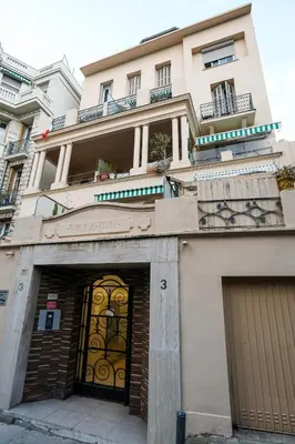 a building with two doors and a garage at Cozy studio in Nice Désambrois in Nice