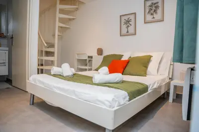 a bed with two stuffed animals on it in a room at Duplex Saveria - Terrace - Netflix - Beach in Nice