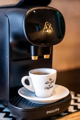 a coffee maker is making a cup of coffee at Duplex Saveria - Terrace - Netflix - Beach in Nice