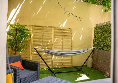 a hammock in the backyard of a house at Duplex Saveria - Terrace - Netflix - Beach in Nice