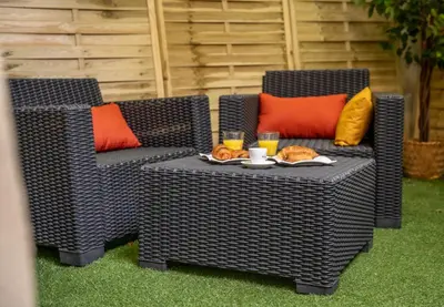 two wicker chairs and a table with food and drinks at Duplex Saveria - Terrace - Netflix - Beach in Nice